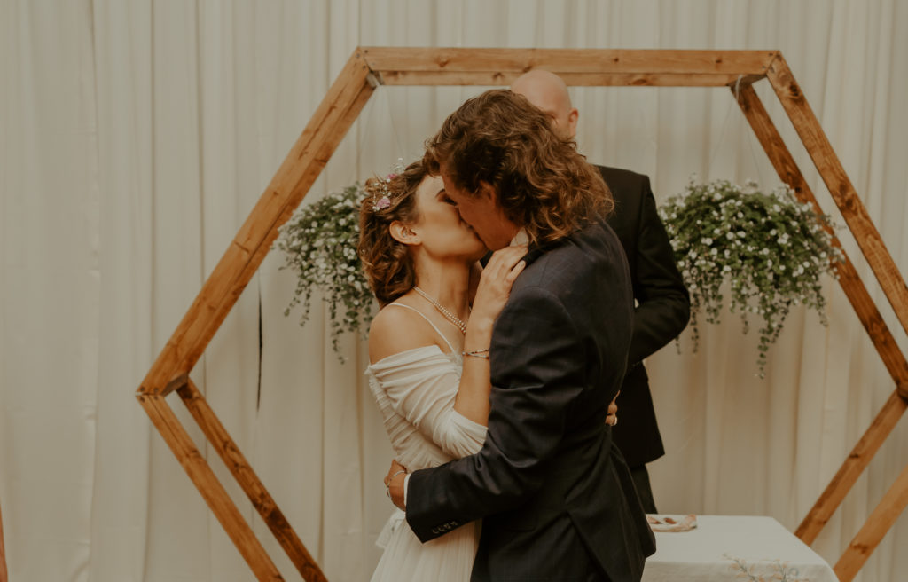 A man and a woman kiss after getting married at their Asheville mountain wedding.