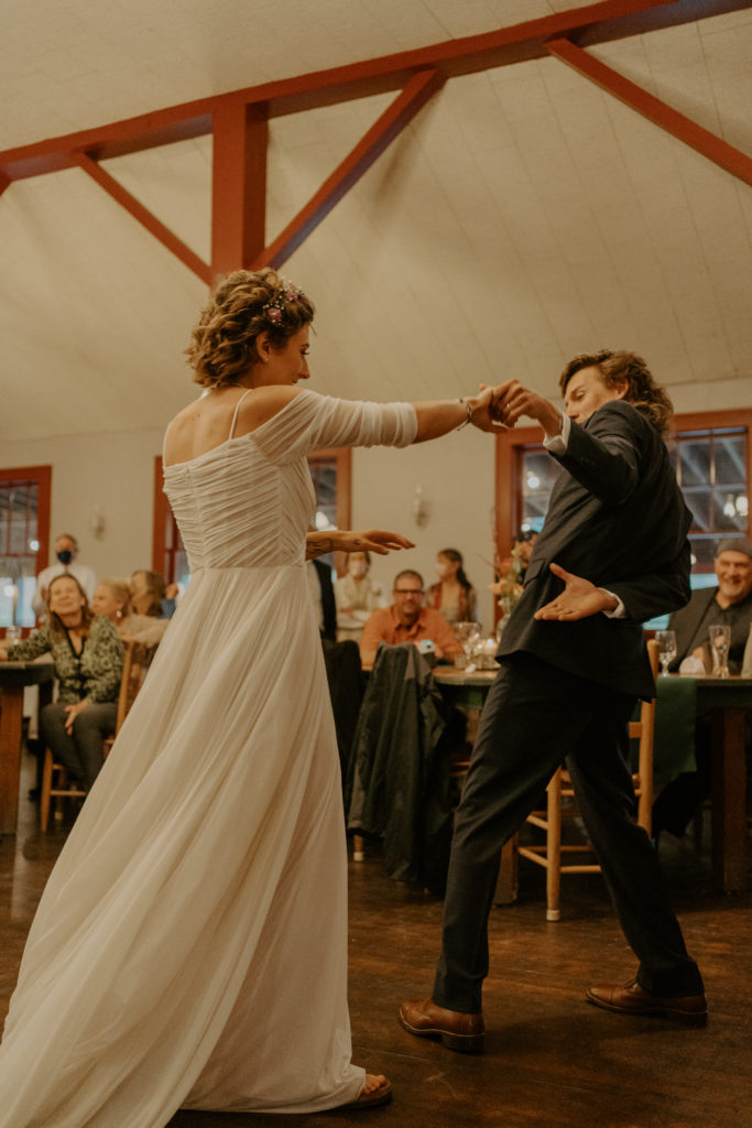 A man and a woman have their first dance during the Asheville mountain wedding. 