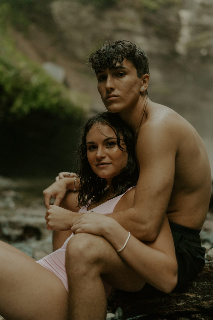 man and women in an Asheville engagement photo shoot at a waterfall