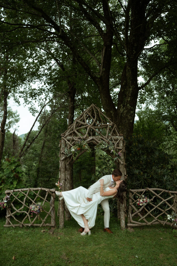 A couple shares their first kiss at the Poplars Wedding Venue near Asheville, North Carolina
