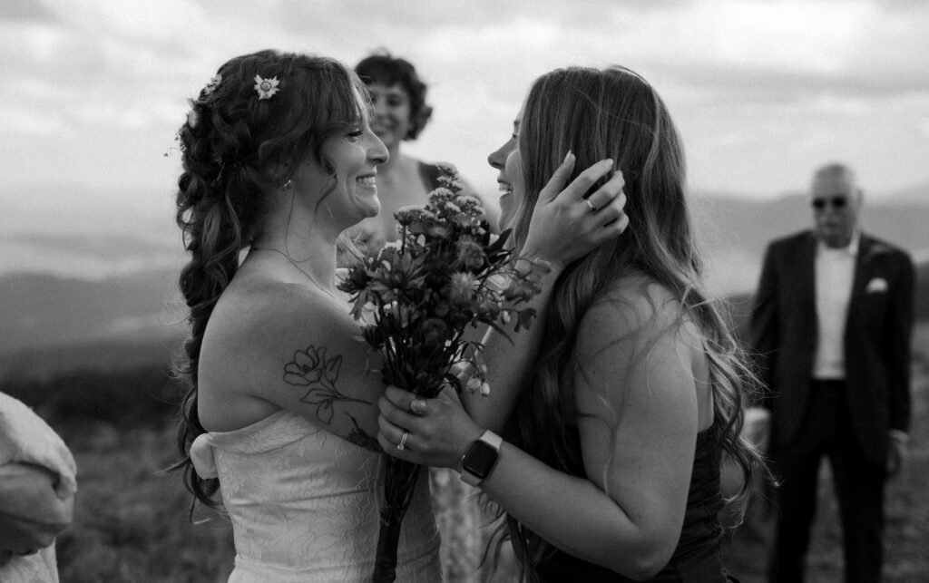 The bride hugging her maid of honor after the ceremony