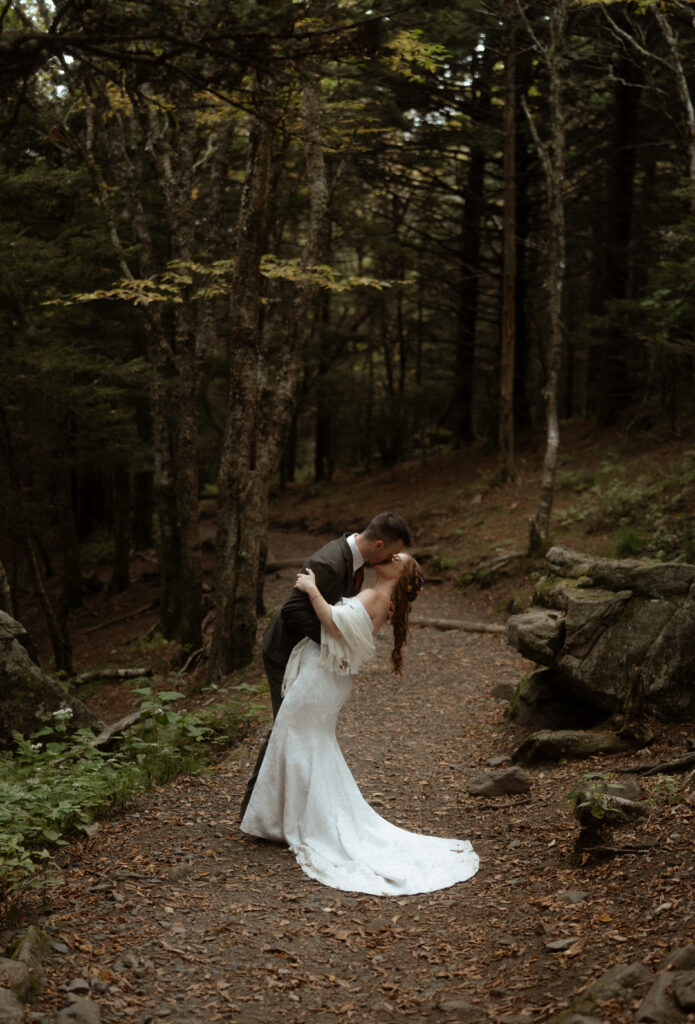 The bridge and groom kissing in the forest 