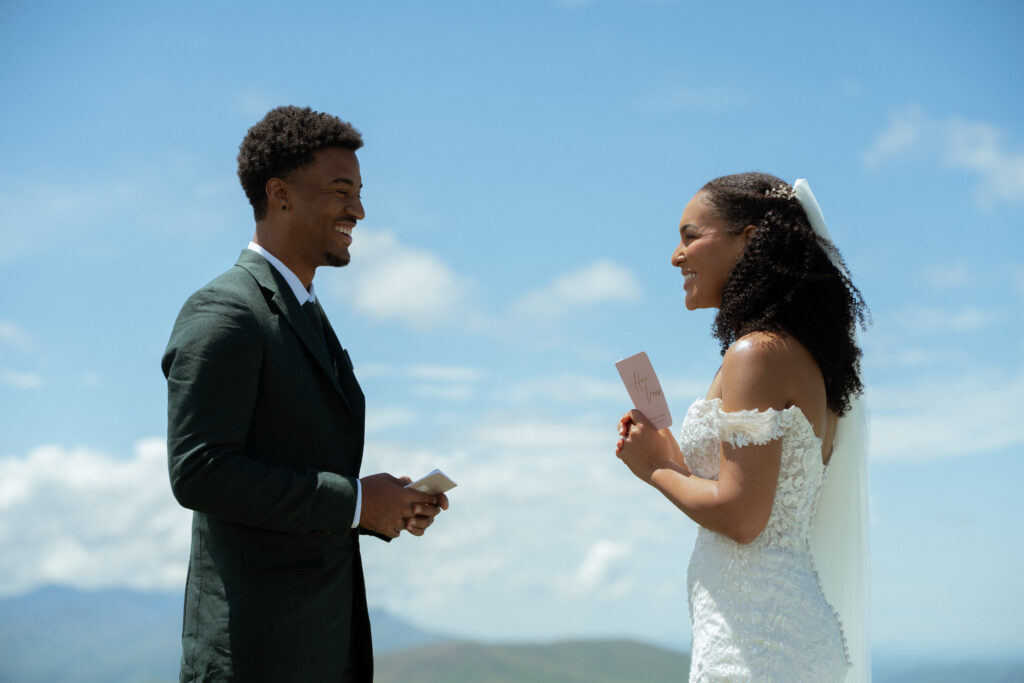 A couple in wedding attire exchanging their vows on top of a mountain in the Blue Ridge Mountains